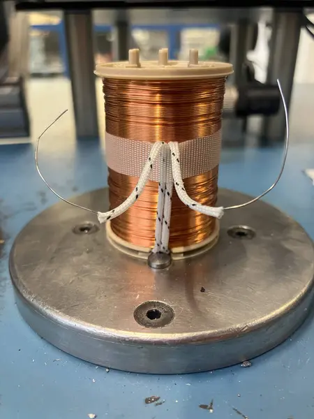 Elektrik ve endüstriyel uygulamalarda kullanılan metal bir zemine sıkıca sarılmış bakır bir bobin. Yüksek kalite fotoğraf