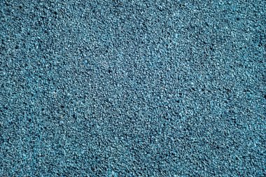 Oyun parklarında kullanılan mavi kauçuk güvenlik yüzeyi. Açık hava oyun alanları için yumuşak ve şok edici bir malzeme. Üst görünüm dokusu.