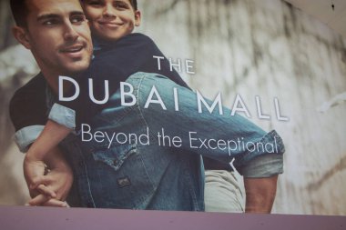 Dubai Alışveriş Merkezi için bir reklam afişi. Sırtında çocuğu olan bir adam, aile dostu bir atmosfer sergiliyor. Metinde 