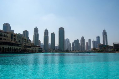 Dubai 'nin gökdelenlerinin ve önplanda canlı turkuaz su gövdesinin yer aldığı gökdelerinin çarpıcı manzarası şehrin mimari güzelliğini gözler önüne seriyor..