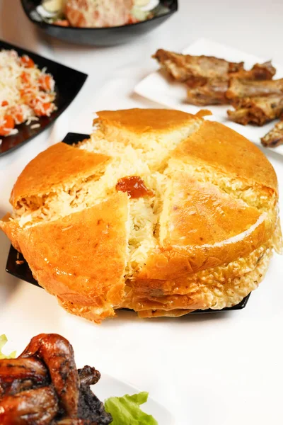 stock image Azerbaijan food. Shah plov in plate on white. Azerbaijan pilaf, meat and dried fruits like dried black plum, apricot, chestnut and raisins.