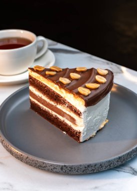 Fıstıklı çikolatalı pasta. Bir fincan sıcak tee 'nin yanında servis ediliyor.