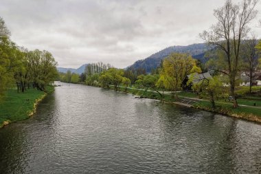 Dunajec Nehri - Kroscienko nad Dunajcem. Köprüden görüntü. Arka planda Pieniny Dağları var. Bulutlu bahar günü