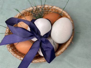 Yayla süslenmiş yeşil bir sepetin içinde paskalya yumurtaları. Yüksek kalite fotoğraf