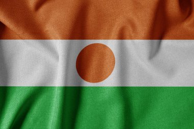 Dokulu Kumaş Arkaplanı Ulusal Bayrağı. İpek desenli bayrak, gerçekçi dalga ve bayrak görünümü. NE Nijer Bayrağı