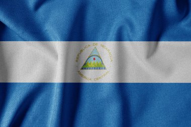 Dokulu Kumaş Arkaplanı Ulusal Bayrağı. İpek desenli bayrak, gerçekçi dalga ve bayrak görünümü. Nikaragua Bayrağı