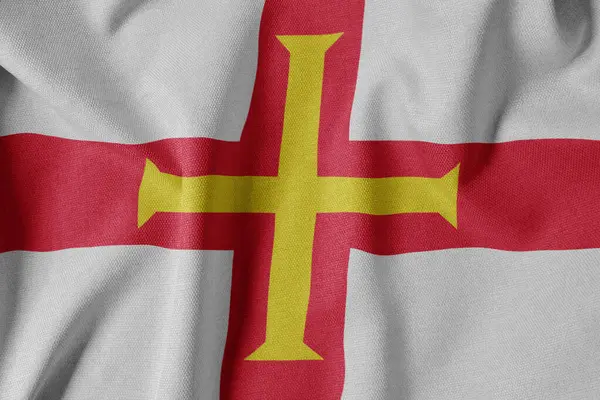 Dokulu Kumaş Arkaplanı Ulusal Bayrağı. İpek desenli bayrak, gerçekçi dalga ve bayrak görünümü. Guernsey 'in GG Bayrağı