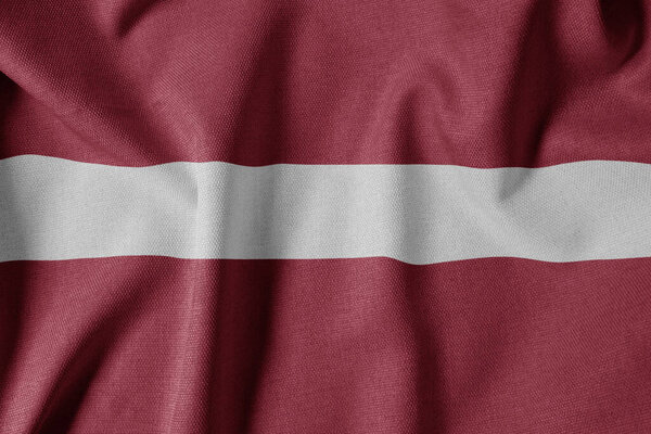 National Flag on Textured Fabric Background. Silk textured flag, realistic wave and flag look. LV  Flag of Latvia