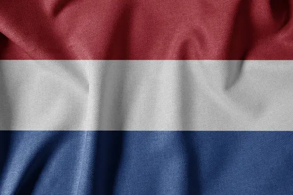 Dokulu Kumaş Arkaplanı Ulusal Bayrağı. İpek desenli bayrak, gerçekçi dalga ve bayrak görünümü. Hollanda 'nın NL Bayrağı