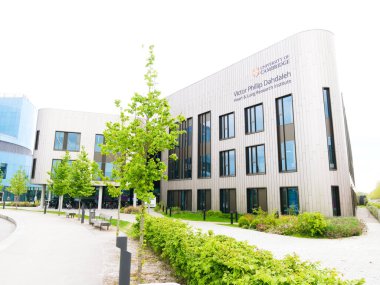 Cambridge, Cambridgeshire / Birleşik Krallık - 25 Nisan 2025: Victor Phillip Dahdaleh Heart ve Lung Araştırma Enstitüsü Cambridge, Birleşik Krallık. Ön planda gri gökyüzü ve ağaç