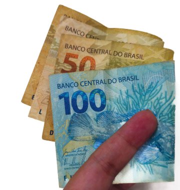 Brezilya 'nın canlı tasarımı & 39;' un notlarının altını çizerek 20, 50 ve 100 'lük banknotları parmaklarıyla gösteren renkli bir Brezilya hayranı..