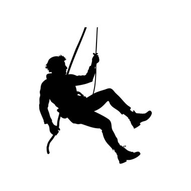 Kaya tırmanışçısının silueti halatlarla kaya yüzeyinden iple iniyor.