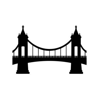 Her iki tarafında yüksek binalar olan görkemli bir köprünün silueti.