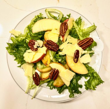 Taze ve sotelenmiş fındıklı elma salatası ve traşlı çedar peyniri..