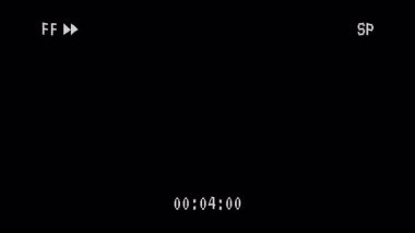 Retro VHS siyah arkaplanda ileri sarılı video kaset. 4K video