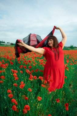 Bir kadın, dalgalı kırmızı ve siyah bir kumaşın üzerinden gizlice bakar. Gizem, cazibe ve doğa ile etkileşim hissini yakalar. Bireysellik ve yaz kaprisleri için idealdir.