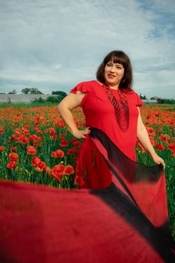 Bir kadın, dalgalı kırmızı ve siyah bir kumaşın üzerinden gizlice bakar. Gizem, cazibe ve doğa ile etkileşim hissini yakalar. Bireysellik ve yaz kaprisleri için idealdir.