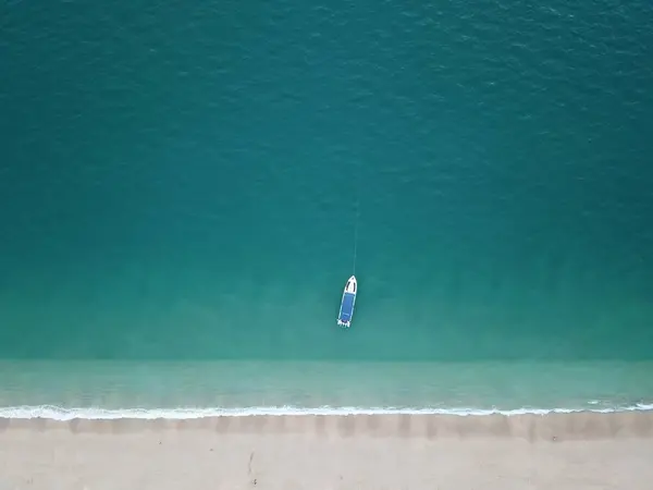 Mavi denizde yelkenli teknenin havadan görünüşü