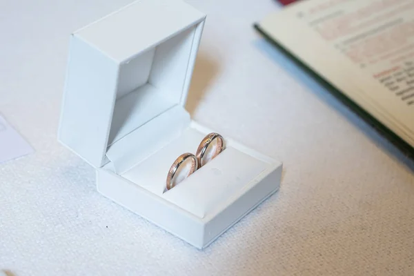 Romantic marriage couple wedding Symbols rings in a white box on a table.