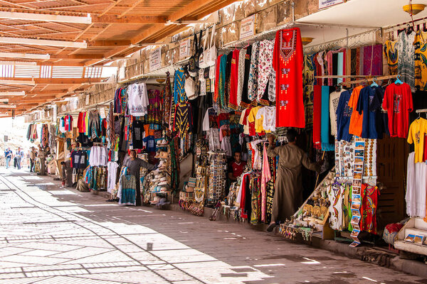 Luxor, EGYPT 18.05.2018 Traditional egyptian colorful palatine and clothes sold at open air market at Temple Hatschepsut.