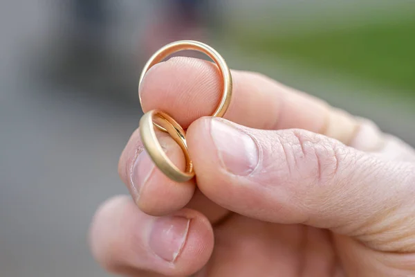 In man fingers are two wedding rings Wedding tradition Gold rings.