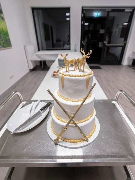 Two rendeer wedding cake toppers with magig sticks and gold elements Harry Potter style.
