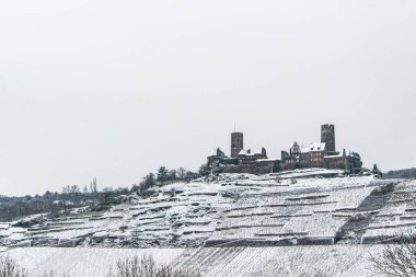 Moselle Nehri üzerindeki tepelere kurulmuş Mosel üzüm bağlarındaki Burg Thurant Şatosu 'ndaki Kış Harikalar Diyarı Almanya' nın Alken kasabası