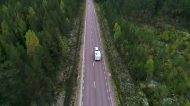 Caravan Camping driving on E45 Highway Road through the wilderness of middle Sweden between the towns of Malung and Oje.