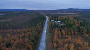 Caravan Camping driving on E45 Highway Road through the wilderness of middle Sweden near the town Lomsele.