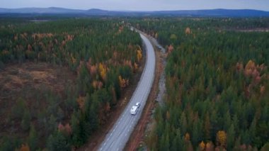 Caravan Camping driving on E45 Higway Road through the wilderness of middle Sweden near the town Lomsele.
