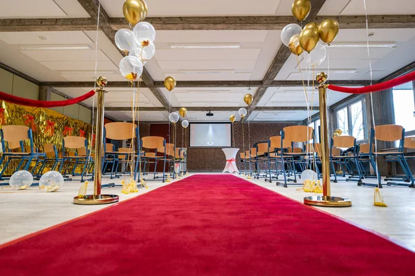 German Abitur Graduation party room decoration with Balloons and Award sculptures red carpet preparations for surprise party
