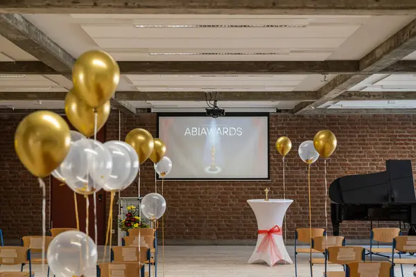 German Abitur Graduation party room decoration with Balloons and Award sculptures red carpet preparations for surprise party