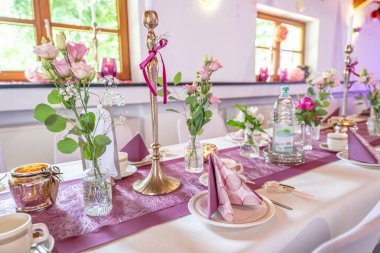 Düğün dekoru. Düğün masasının dekorasyonunu beyaz, pembe çiçekler ve mumlarla kapat. Düğün çiçeği konsepti