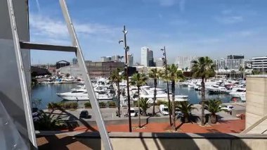 Barselona, İspanya 'da modern binalar ve palmiye ağaçları liman limanına demirlemiş yatlar