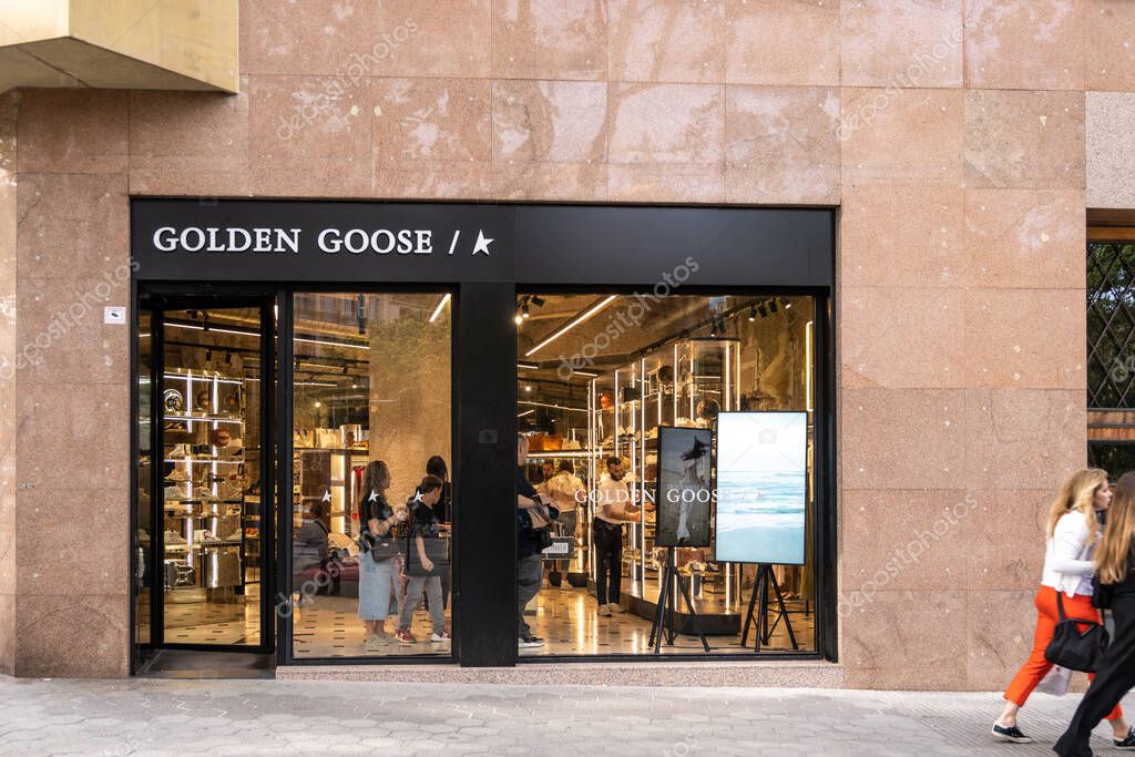 Barcelona, Spain-April 29, 2023. Golden Goose is an Italian high fashion trainer brand based in Venice, Italy. Logo on the front door