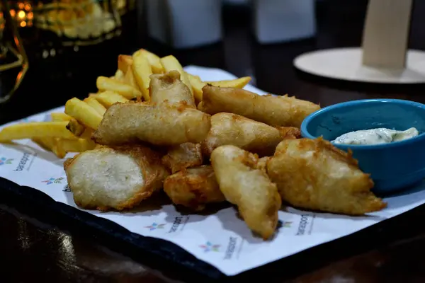 Patates kızartması ve kızarmış balığın yakın plan çekimi.