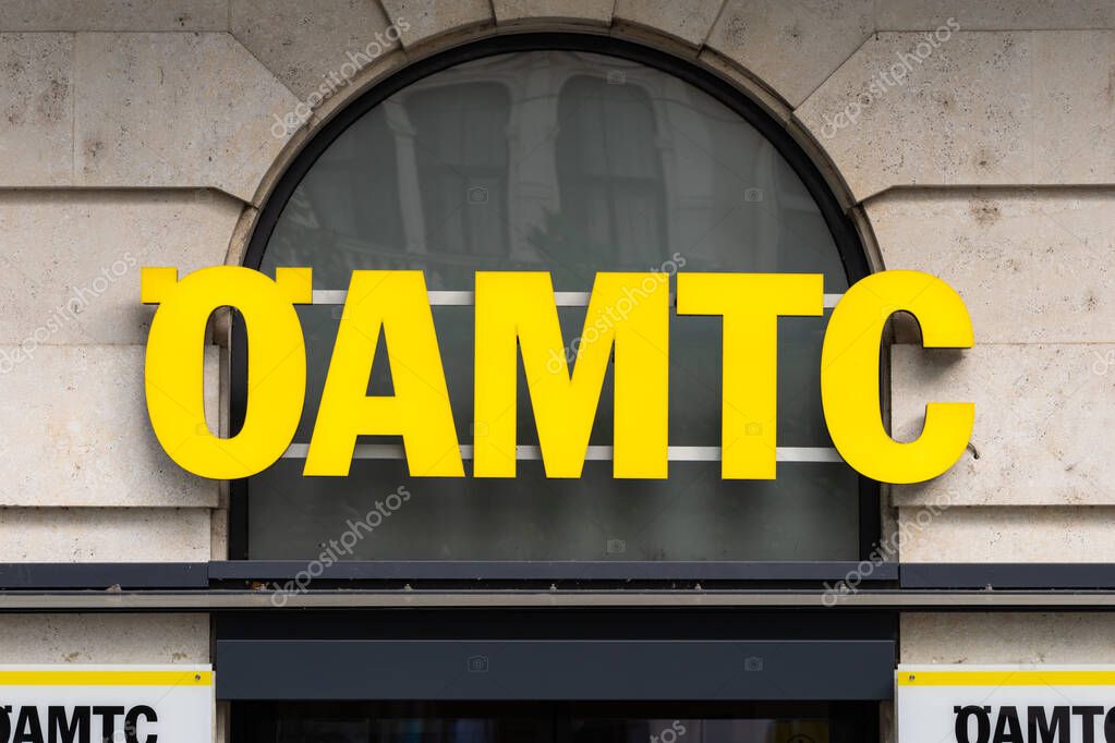 VIENNA, AUSTRIA - 28. July 2024: OEAMTC logo sign of the Austrian motor club. Close-up of the signage on a building exterior. Mobility association helping with roadside assistance.