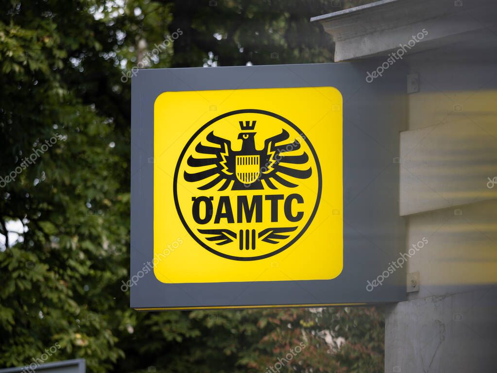 VIENNA, AUSTRIA - 28. July 2024: OEAMTC logo sign of the Austrian motor club. Close-up of the signage on a building exterior. Mobility association helping with roadside assistance.