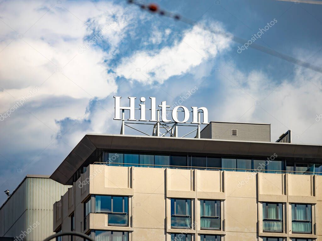 VIENNA, AUSTRIA - 29. July 2024: Hilton logo sign on the hotel building exterior of the Hilton Vienna Park. Multinational company in the hospitality industry. 5-star hotel for tourism in Europe.