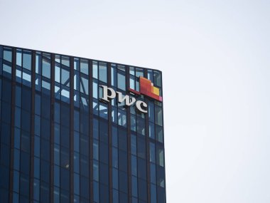 VIENNA, AUSTRIA - 30. Temmuz 2024: Bir gökdelen ofis binasının PWC logosu. Donau City Kulesi ön cephesinde Price Waterhouse Coopers imzası var. Profesyonel danışman ve danışman şirket.