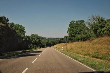 The lush greenery of the surrounding countryside frames the scene, while the crisp blue sky adds a touch of serenity. Every corner whispers stories of tradition, simplicity, and the quiet beauty of rural life. Whether it s the meticulously kept