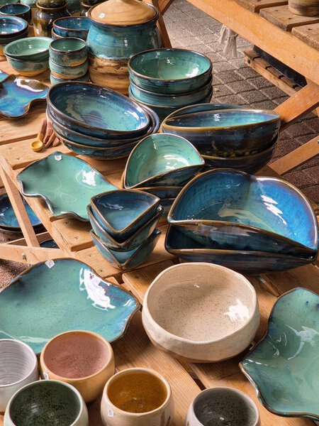 ceramic and clay emerald colored dishes on the table. Handmade.