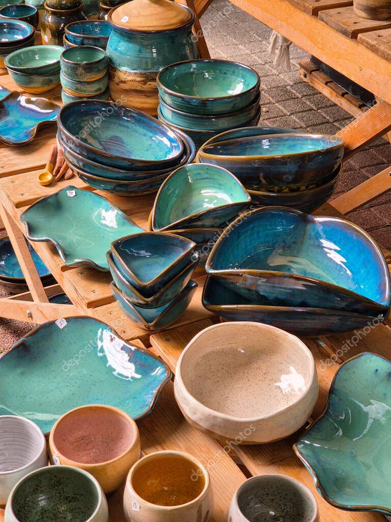 Ceramic and clay emerald colored dishes on the table. Handmade.