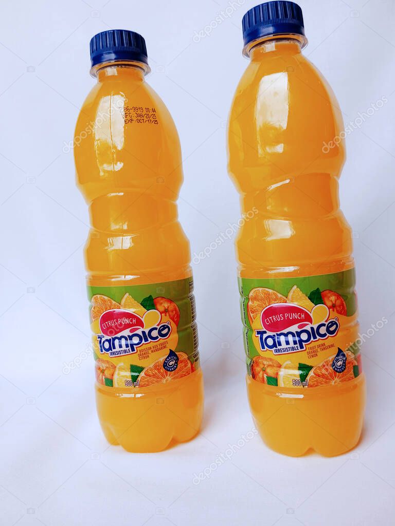 Kumasi, Ghana - February 25, 2025: Bottles of Tampico fruit drink on white background, produced in Ghana by Acadia Industries Limited.