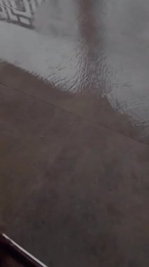 Şiddetli yağmurdan sonra evdeki verandada ya da verandada su baskını. Şiddetli yağış sonrası. Yağmur yağarken küller üzerinde durgun su.