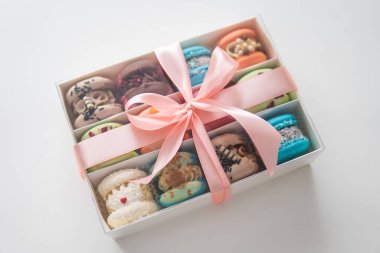 acaroons Tasty. Closeup of different colors macarons cakes. Sweet almond colorful pastel pink blue yellow green macaron. Sweet colorful macarons on white background. Tasty colourful macaroons.