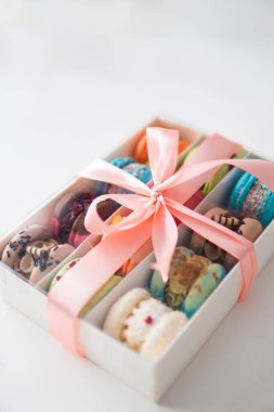 Close-up of different colors macarons cakes of in white background. Culinary and cooking concept. Colourful Dessert. acaroons Tasty.