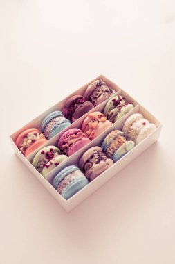 Macaroons in box. Minimal concepts falling macaroons pattern above, food natural background Sweet macarons or macaroons, flavored cookies paper box on white background. French macaroon cake.