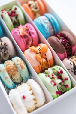 Culinary and cooking concept. Colourful Dessert. Tasty colourful macaroons. acaroons Tasty. Close up of different colors macarons cakes of in white background.