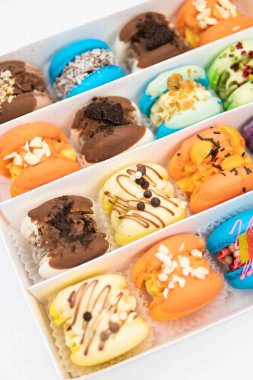 Culinary and cooking concept. Colourful Dessert. Tasty colourful macaroons. acaroons Tasty. Close up of different colors macarons cakes of in white background. Sweet colorful